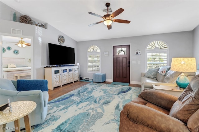 living room featuring ceiling fan, lofted ceiling, wood-type flooring, and plenty of natural light