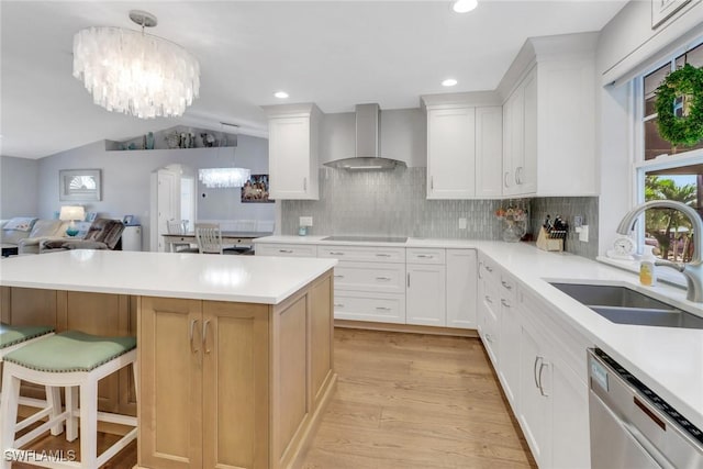 kitchen with white cabinetry, dishwasher, sink, and wall chimney exhaust hood