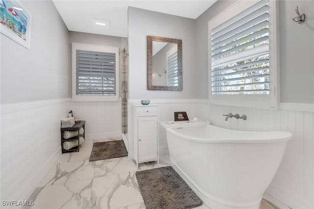 bathroom featuring independent shower and bath