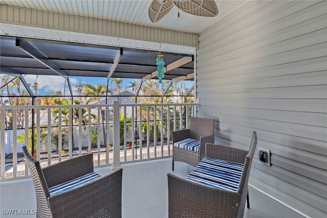 sunroom / solarium featuring ceiling fan