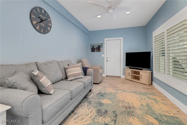 living room with ceiling fan and light hardwood / wood-style floors