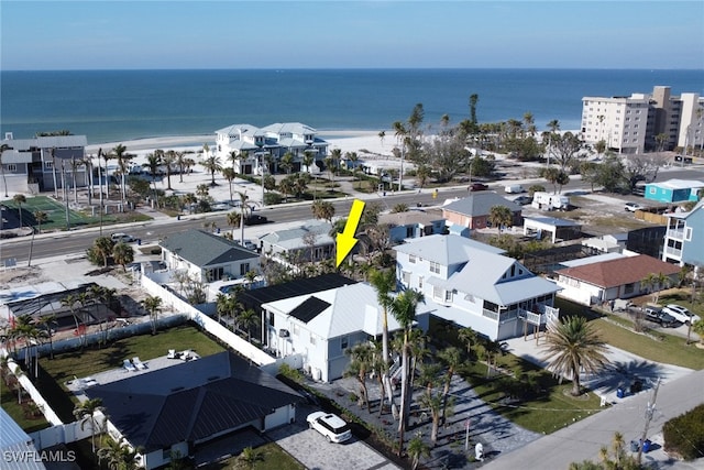 birds eye view of property with a view of the beach and a water view