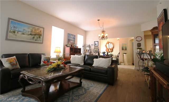 living room with light hardwood / wood-style floors and an inviting chandelier