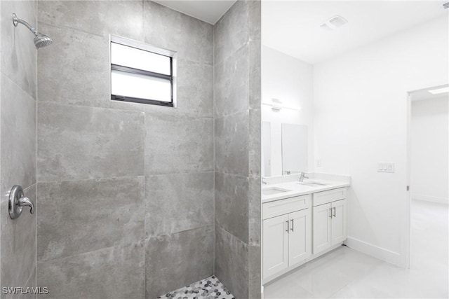 bathroom featuring vanity and tiled shower