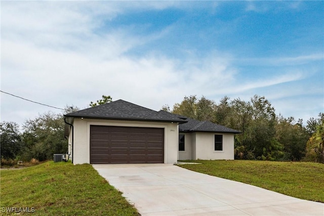 view of front of house featuring cooling unit, a garage, and a front lawn