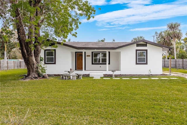 single story home featuring a front lawn