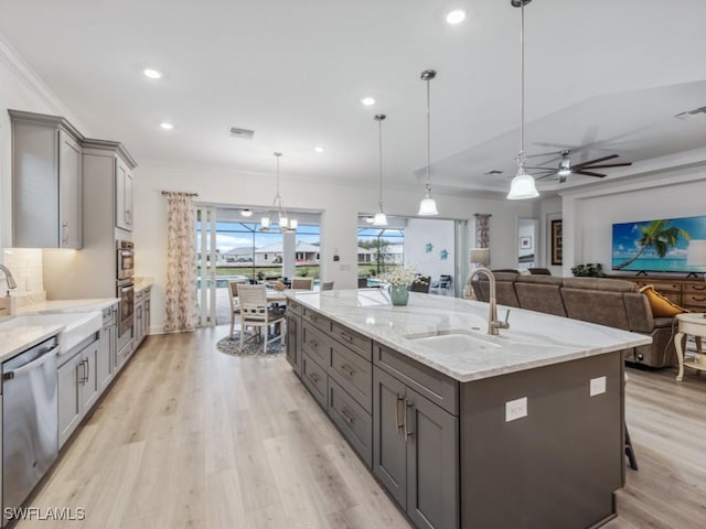 kitchen featuring appliances with stainless steel finishes, sink, hanging light fixtures, and gray cabinetry