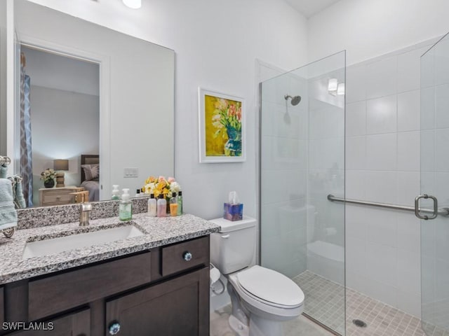 bathroom with an enclosed shower, vanity, and toilet