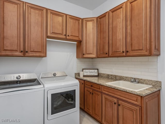 washroom featuring cabinets, separate washer and dryer, and sink