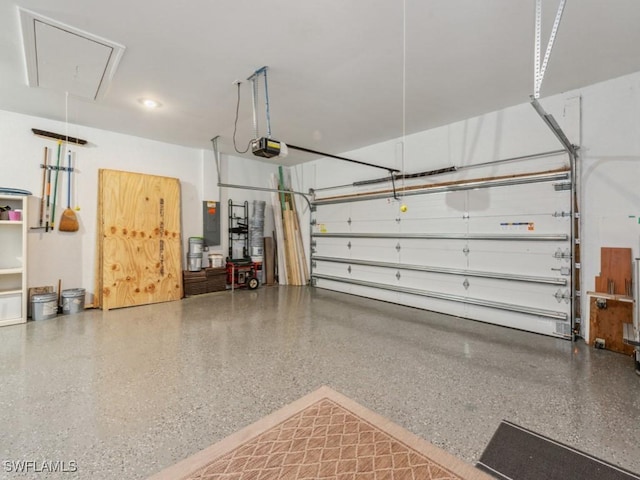 garage with a garage door opener and electric panel