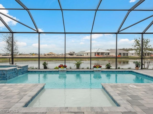 view of pool featuring a water view, an in ground hot tub, a lanai, and a patio