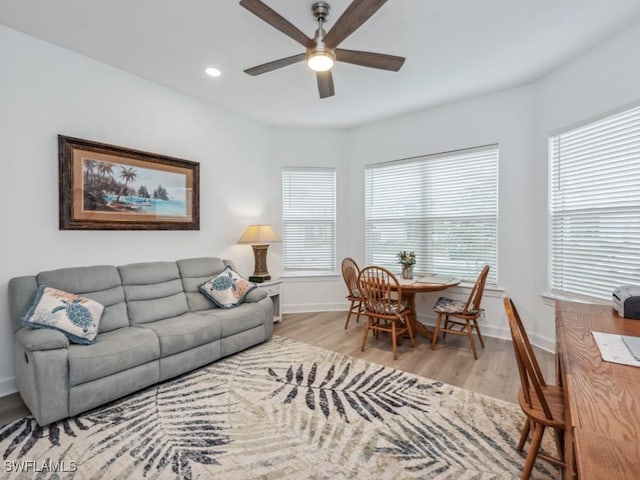 living room featuring ceiling fan and light wood-type flooring