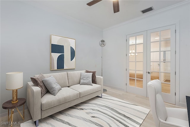 15745 Cortina St, Naples, FL 34114 - living room featuring ornamental molding, light wood-style flooring, ceiling fan, french doors, and baseboards