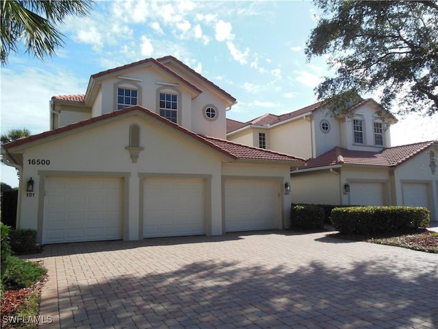 mediterranean / spanish home with a garage