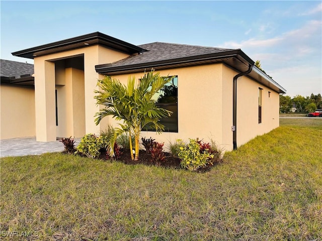 view of property exterior featuring a lawn