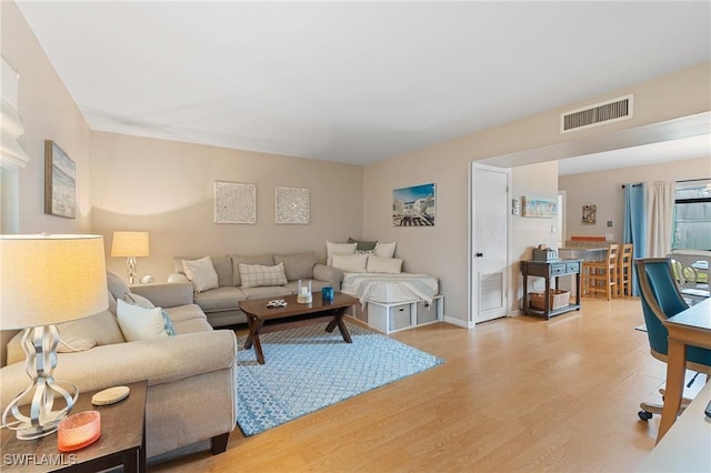 living room with light hardwood / wood-style flooring