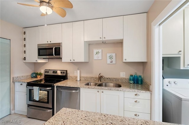 kitchen with sink, white cabinetry, stainless steel appliances, and washer / clothes dryer