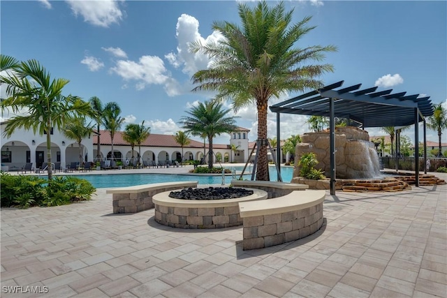 view of pool with pool water feature and a pergola