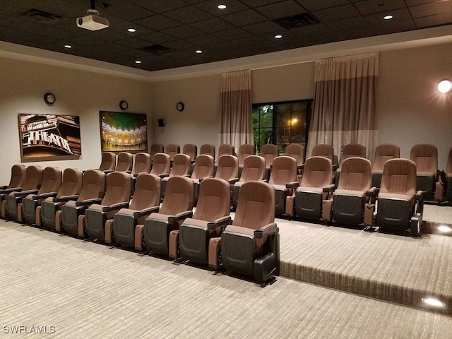 carpeted cinema featuring a paneled ceiling and a high ceiling