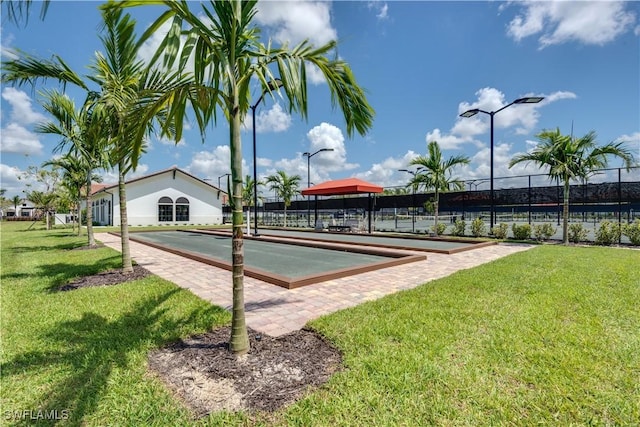 view of property's community with a lawn