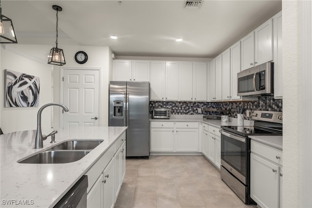 kitchen featuring light stone countertops, sink, white cabinetry, and stainless steel appliances