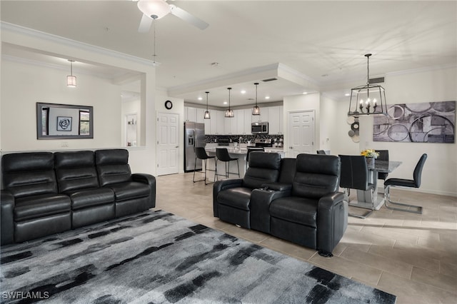 living room featuring light tile patterned floors, ceiling fan with notable chandelier, and ornamental molding