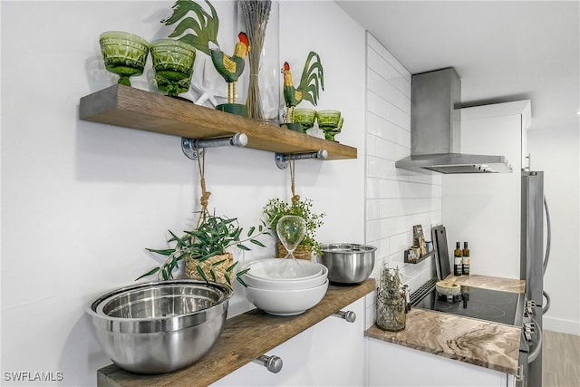 kitchen featuring electric stove, wall chimney exhaust hood, and hardwood / wood-style floors