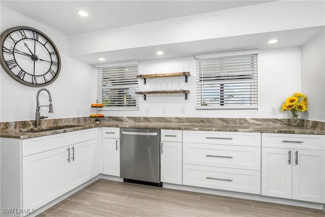 kitchen with dishwasher, sink, white cabinets, and dark stone counters