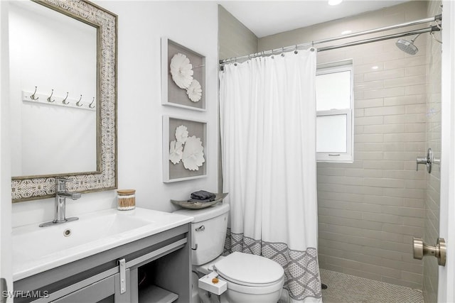 bathroom with vanity, toilet, and curtained shower