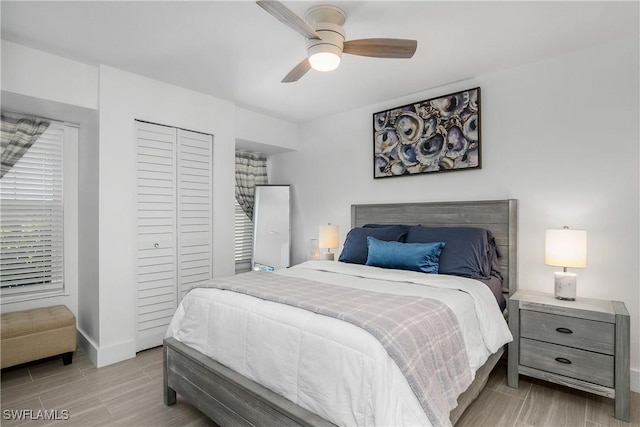 bedroom with ceiling fan and a closet