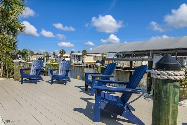 deck with a dock and a water view