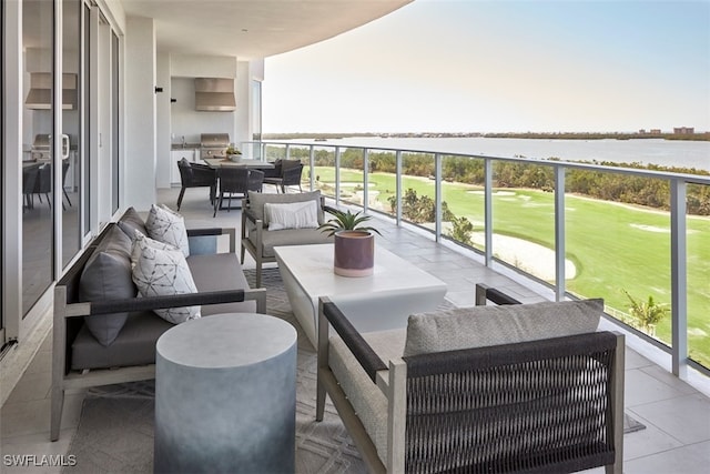 balcony with grilling area, an outdoor living space, view of golf course, and a water view