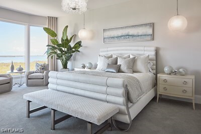 bedroom with a notable chandelier and carpet flooring