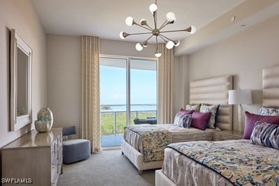 carpeted bedroom with access to exterior, multiple windows, and a notable chandelier