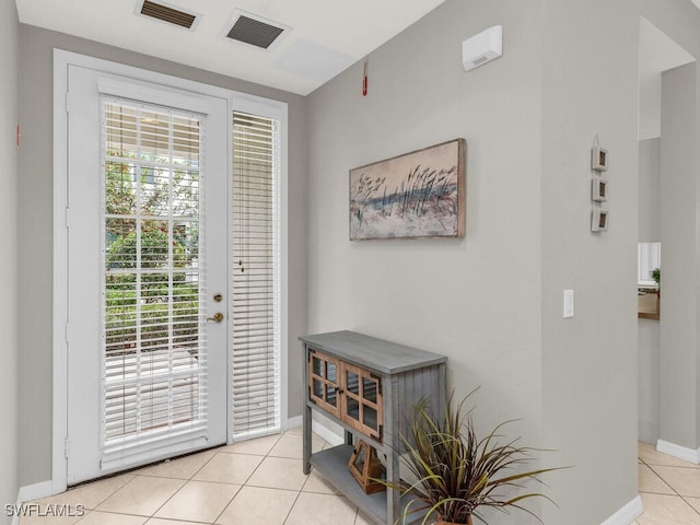 entryway featuring light tile patterned floors