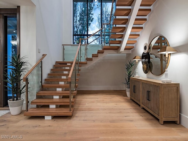 stairs with hardwood / wood-style flooring