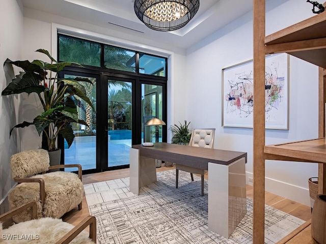 office space featuring a chandelier and light hardwood / wood-style flooring