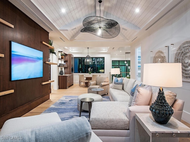 living room featuring wood walls and light hardwood / wood-style flooring