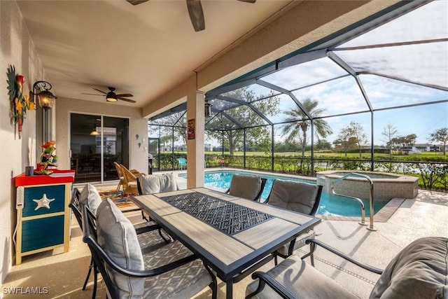 view of patio / terrace featuring a pool with hot tub, a water view, and glass enclosure