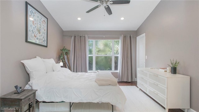 bedroom with vaulted ceiling, ceiling fan, and light hardwood / wood-style flooring