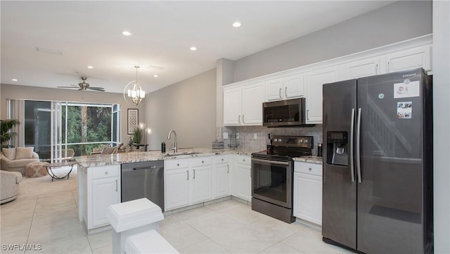 kitchen featuring kitchen peninsula, appliances with stainless steel finishes, white cabinets, and sink