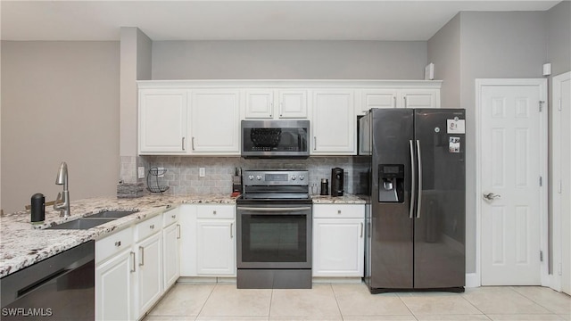 kitchen featuring stainless steel appliances, decorative backsplash, white cabinetry, and sink