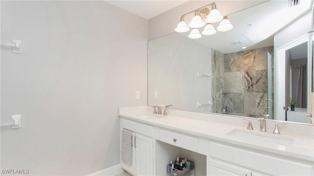 bathroom featuring a shower with door, an inviting chandelier, and vanity