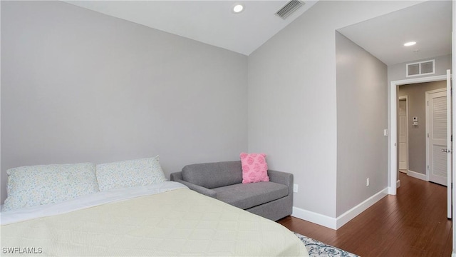 bedroom with dark hardwood / wood-style flooring