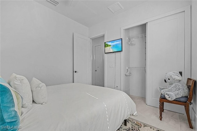 tiled bedroom with a closet