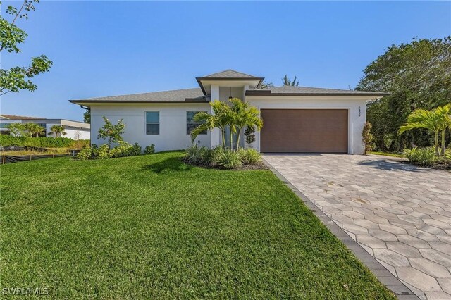 view of front of home featuring a garage and a front lawn