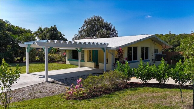 rear view of house featuring a yard and a carport