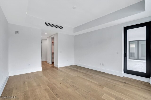 spare room with light hardwood / wood-style floors