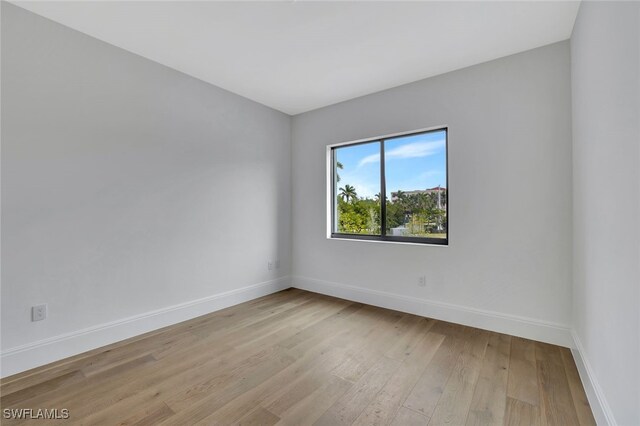 unfurnished room with light hardwood / wood-style floors