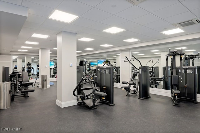 exercise room with a paneled ceiling